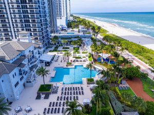Oceanfront pool and beach service at Green Diamond Miami Beach